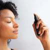 Kahina Giving Beauty Toning Mist- Model shown spraying product onto face
