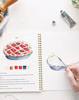 Emily Lex Studio Baking Watercolor Workbook - Model shown painting pie
