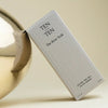 Tenoverten The Rose Soak - packaging leaning against gold ball