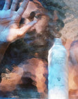 Flamingo Estate Organics Peppermint & Juniper Berry Body Wash - model with body wash bottle behind glass