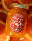 Marmalade Grove Cara Cara & Hibiscus Marmalade - Overhead shot of product on top of orange slices