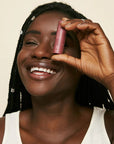 Pink House Organics Lip Tint - Merlot - model holding lip balm