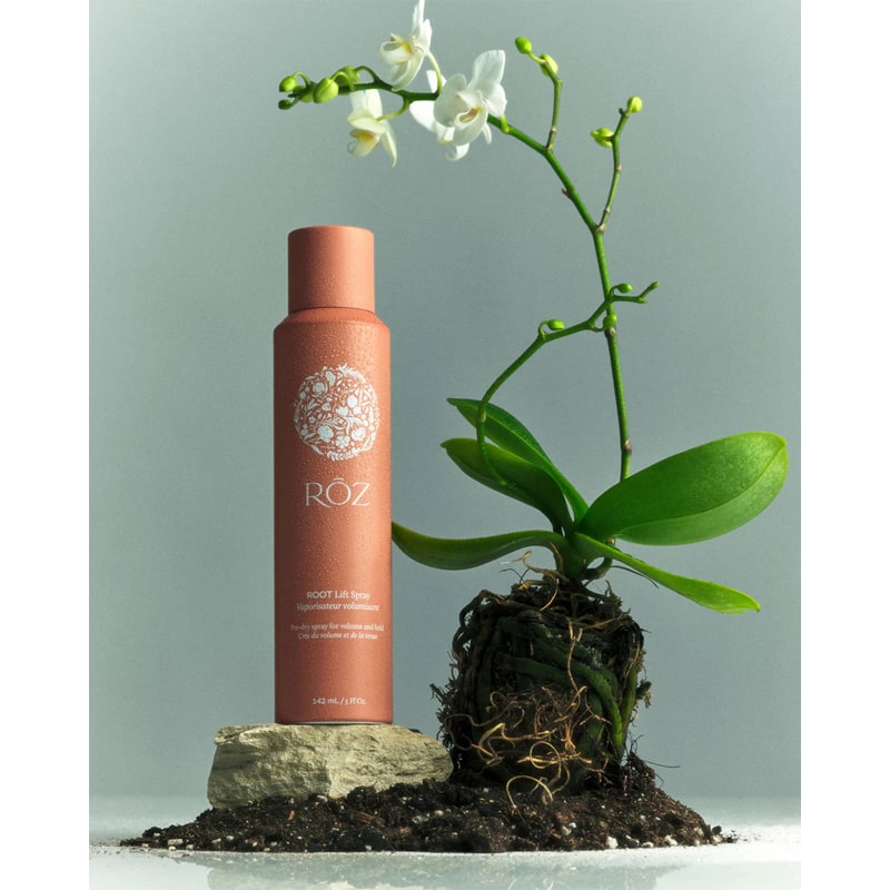 Roz Root Lift Spray- Product shown next to flower