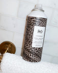 R+Co Chainmail Thermal Protection Styling Spray - Product shown on towel