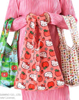 Baggu Standard Reusable Bag Set of 3 - Hello Kitty and Friends- model shown holding 3 bags