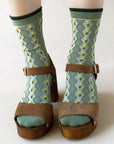 Tiepology Little Daisy Diamond Shape Socks - Warm Sage- Closeup of model wearing product