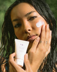 Linne PROTECT Daily Mineral Sunscreen - Model shown applying product to face