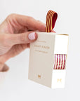 Bespoke Letterpress Red Gold Foil Striped Ribbon - Model shown holding ribbon box