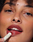 Yolaine Tinted Lip Balm - Brioche - Model shown applying product
