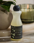 Eucalan Eucalyptus Delicate Wash - Lifestyle shot of Delicate Wash by potter plant and lit candle