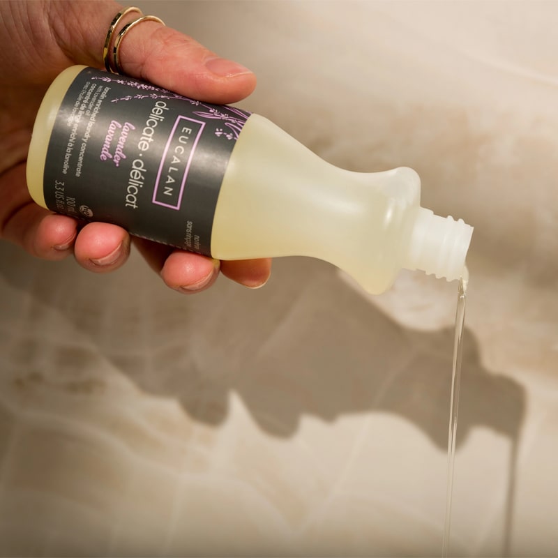 Eucalan Lavender Delicate Wash - Model shown pouring out Delicate Wash detergent 