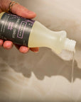 Eucalan Lavender Delicate Wash - Model shown pouring out Delicate Wash detergent 