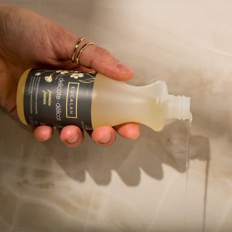 Eucalan Jasmine Delicate Wash - Model shown pouring Delicate Wash out of the bottle