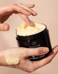 Odacite C-Smooth Hydra-Firm Body Polish - Model shown applying product to hand (227 g)