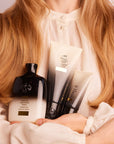 Oribe Gold Lust Ritual Set - Model shown holding products in arms