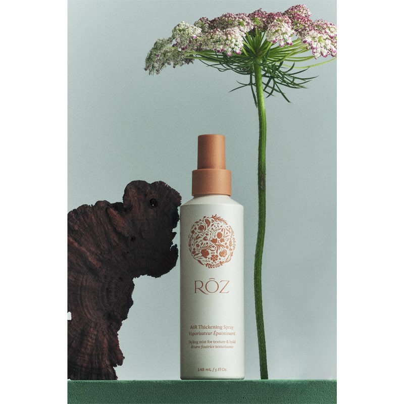 Roz Air Thickening Spray - Product shown with flowers