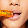 Nuxe Reve de Miel® Honey Lip Care - Closeup of model holding product against lips