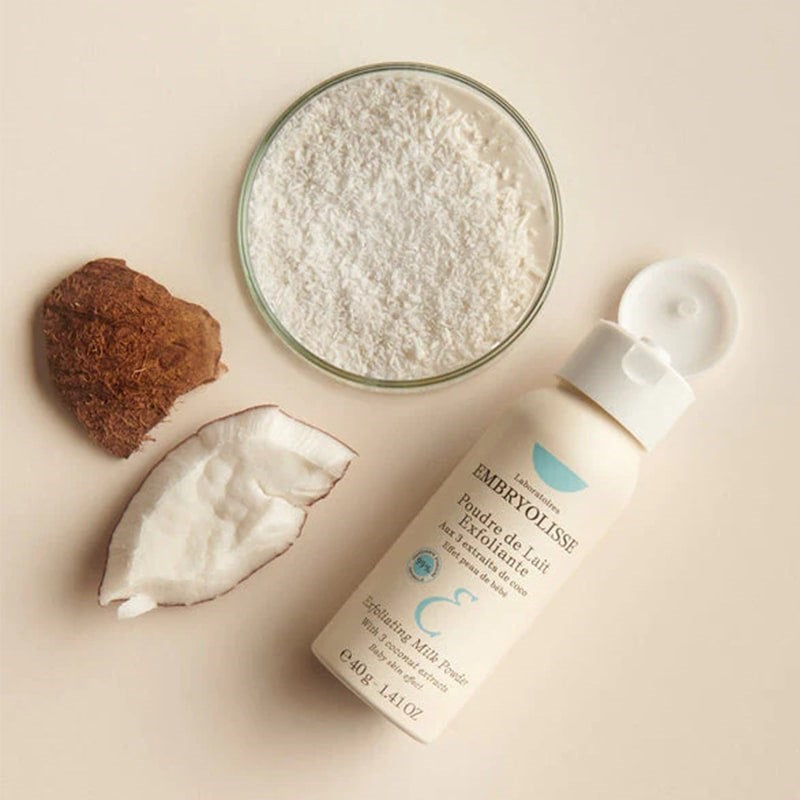 Embryolisse Exfoliating Milk Powder - Product shown with powder and coconut