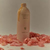 Flamingo Estate Organics Euphoria Hand Soap - product dripping from bottle surrounded by roses