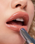 Kosas Wet Stick Moisturizing Lip Shine - Heatwave - Closeup of model applying product