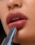 Kosas Wet Stick Moisturizing Lip Shine - Island High - Closeup of model applying product