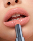 Kosas Wet Stick Moisturizing Lip Shine - Skinny Dip - Closeup of model applying product 