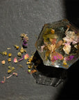 Leaves and Flowers Ikebana Loose Leaf Tea - loose leaf tea spread out on table and in glass of water