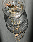 Leaves and Flowers Mt Tamalpais Loose Leaf Tea - loose leaf tea in glass of water and spread out on table