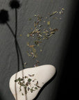Leaves and Flowers Serenitas  Loose Leaf Tea - loose leaf tea spread out on table and on rock