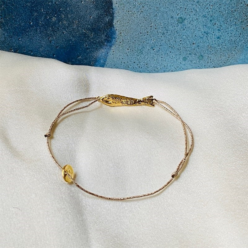 Sophie Deschamps Bijoux Ablette Gold Plated Fish Bracelet - Product shown on white fabric