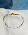 Sophie Deschamps Bijoux Ablette Gold Plated Fish Bracelet - Product shown on white fabric