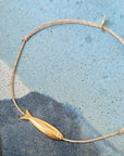 Sophie Deschamps Bijoux Gold Plated Long Fish Bracelet - Product shown on blue background