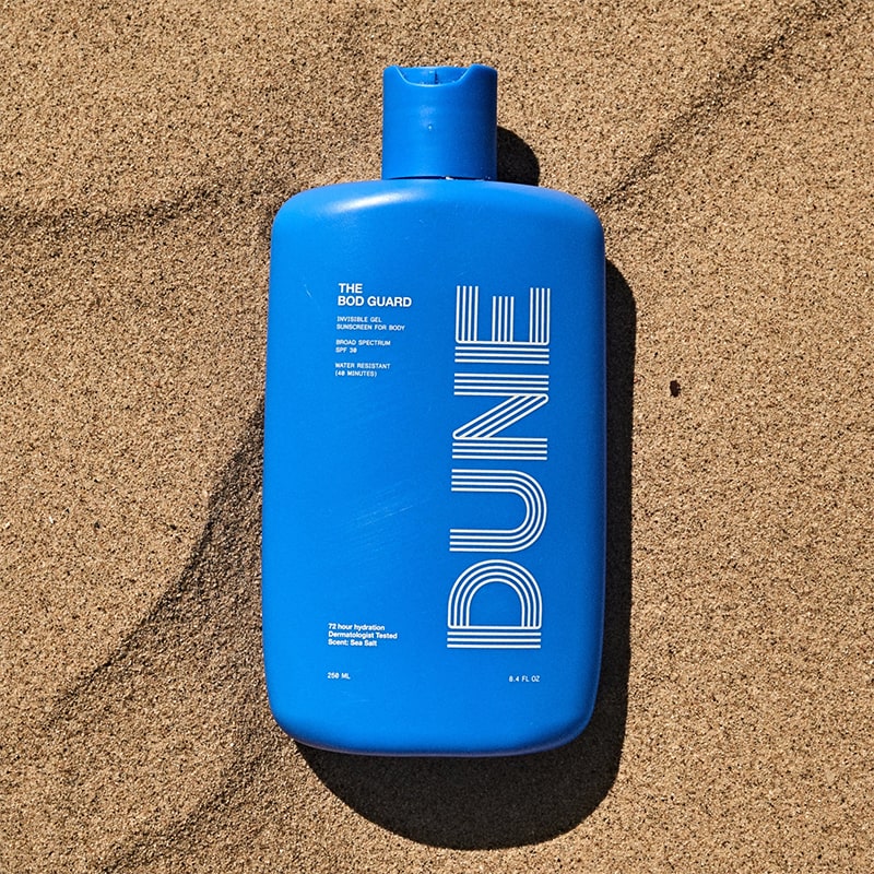 DUNE Suncare The Bod Gard - Product shown in sand