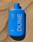 DUNE Suncare The Bod Gard - Product shown in sand