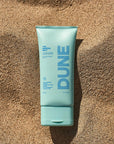 DUNE Suncare The Mineral Melt - Product shown on sand