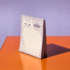 Negative Space Floral Cat - Risograph A2 Notepad - notepad standing upright on desk
