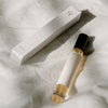 Orchid + Ash Idyll Perfume Travel Spray - Jasmine Incense + Vanilla - bottle and packaging shown on top of cloth