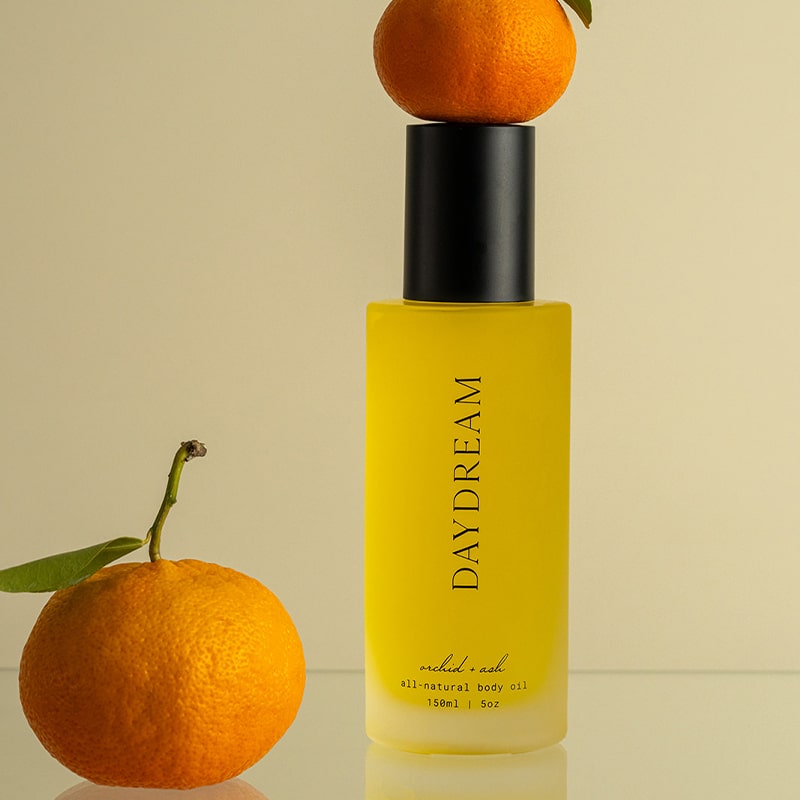 Orchid + Ash Daydream All-Natural Body Oil - Orange + Neroli - product shown with oranges