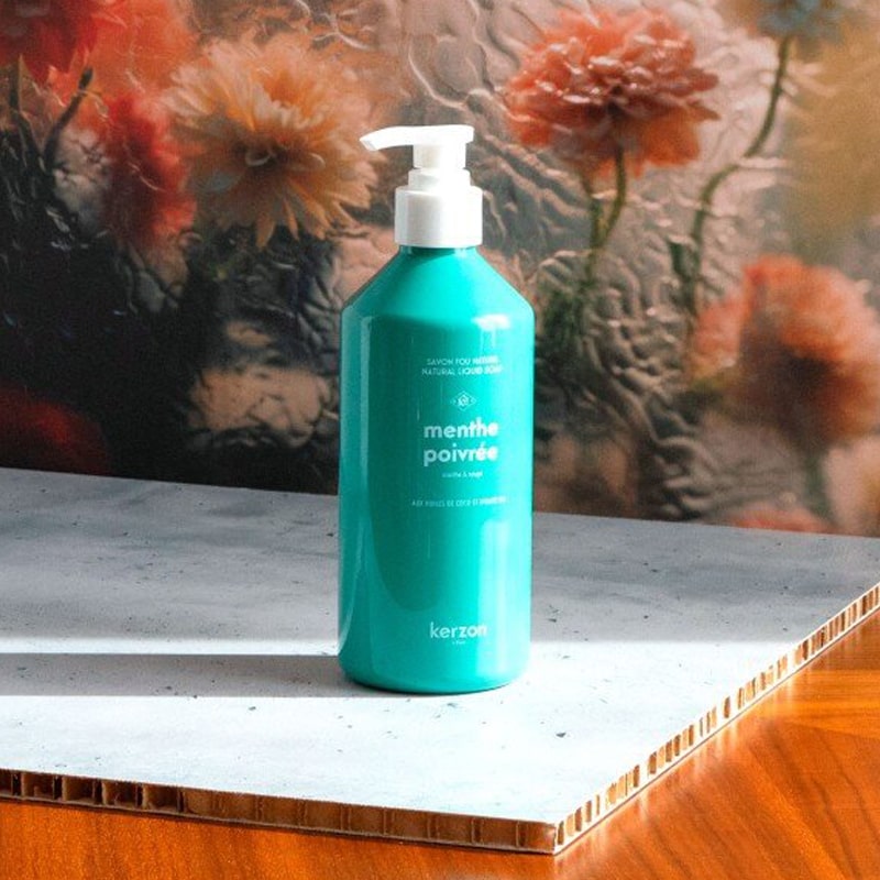 Kerzon Liquid Body Soap - Menthe Poivrée - Product shown on table in front of glass and flowers