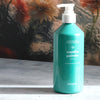 Kerzon Natural Liquid Soap - Menthe Poivrée (500 ml) - product shown in front of floral background. 