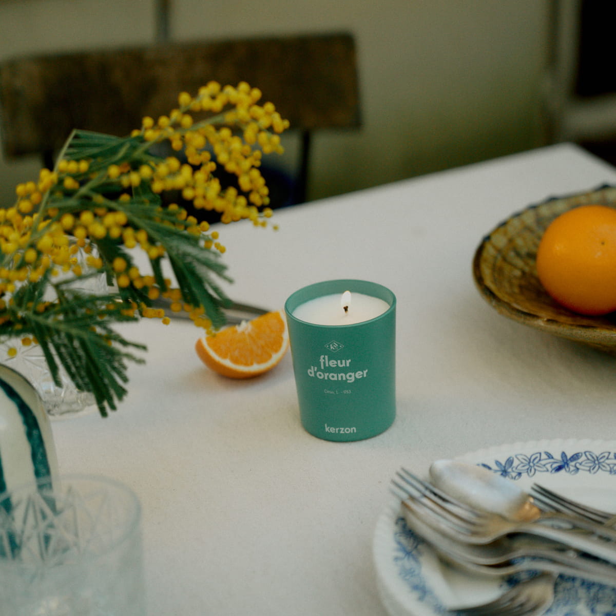 Kerzon Fragranced Candle - Fleur d'Oranger (190 g) - product shown next to orange on table.