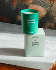 Kerzon Fragranced Candle - Menthe Poivrée - candle sitting on top of packaging on table