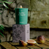 Kerzon Fragranced Candle - Feuilles de Figuier (190 g) - product shown lit on top of packaging. 