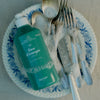 Kerzon Dishwashing Liquid - Fleur d'Oranger (500 ml) - product shown in bowl with dishes. 