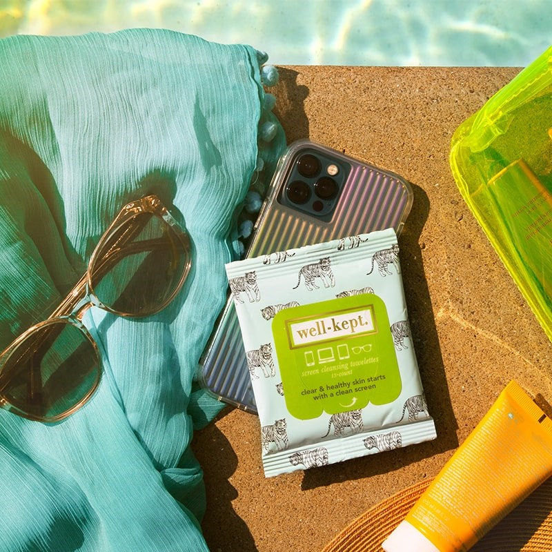 Well-Kept Big Cat Screen Cleansing Towelettes - Tech Wipes - product by pool surrounded by glasses, phone, and sunscreen