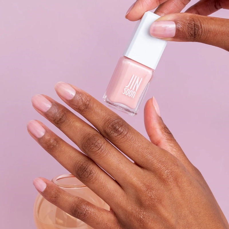 JINsoon Nail Lacquer - Whisper - model holding product and wearing nail polish