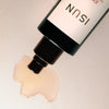 Close up of ISUN Garnet Grounding Body Oil (100 ml) showing product swatch