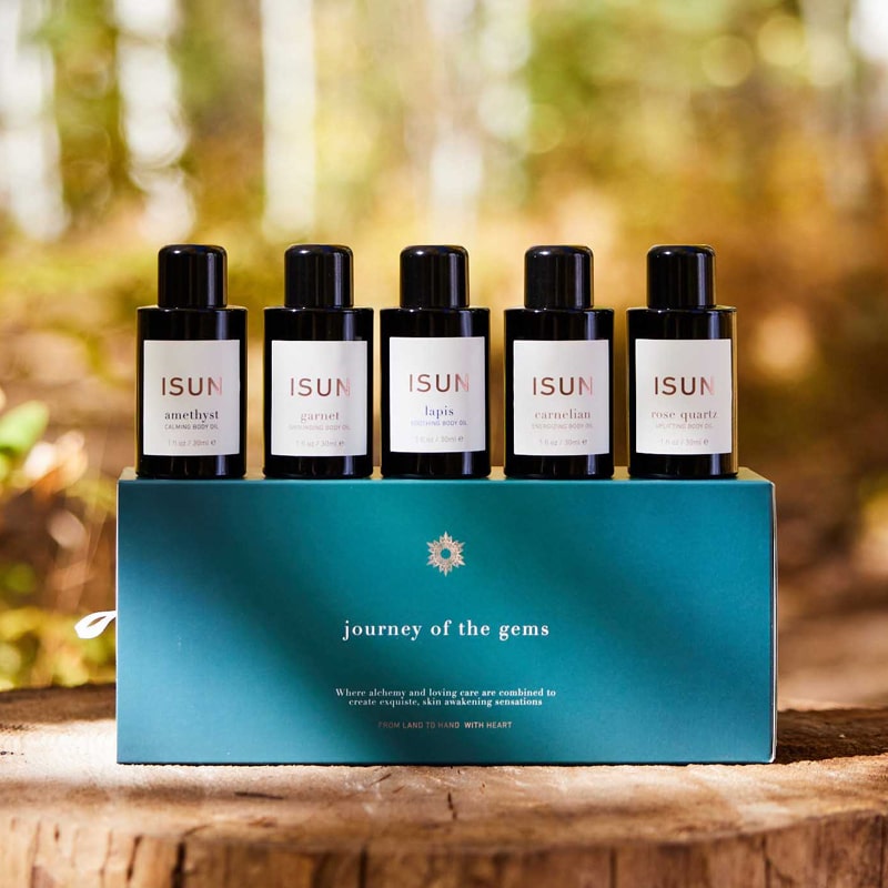 ISUN Journey of the Gems Gift Set - bottles sitting in a row on top of packaging in forest