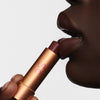 Augustinus Bader The Tinted Lip Balm - Shade 3 - model holding product touching lips