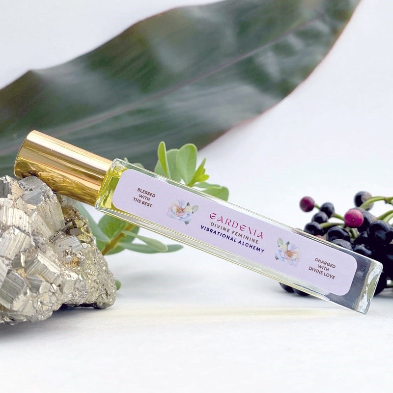 The Sacred Essence Gardenia Vibrational Alchemy - product shown next to plants and minerals